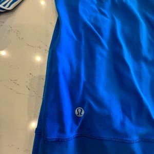 Royal blue Lululemon workout jacket with blue and white striped sleeves